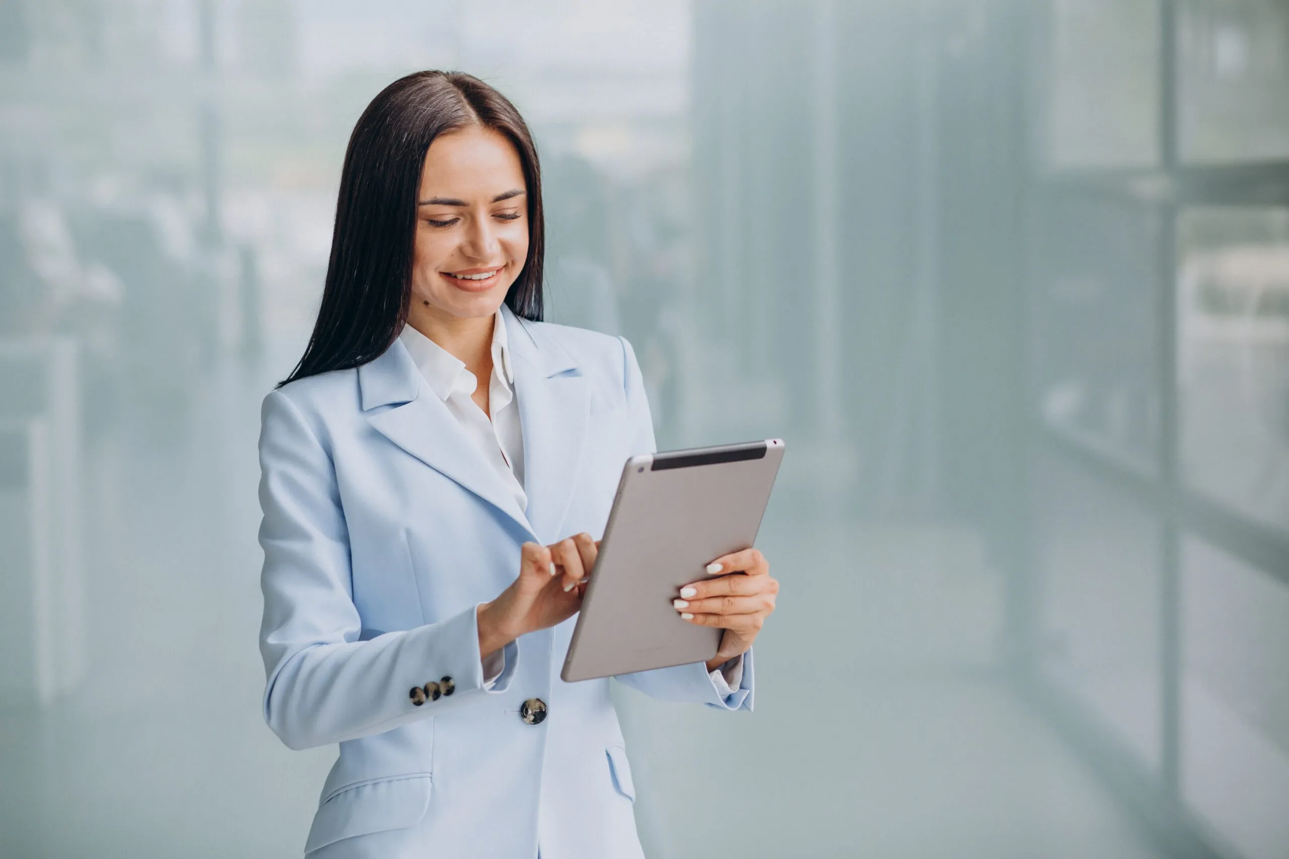 young-business-woman-isoled-holding-tablet-scaled